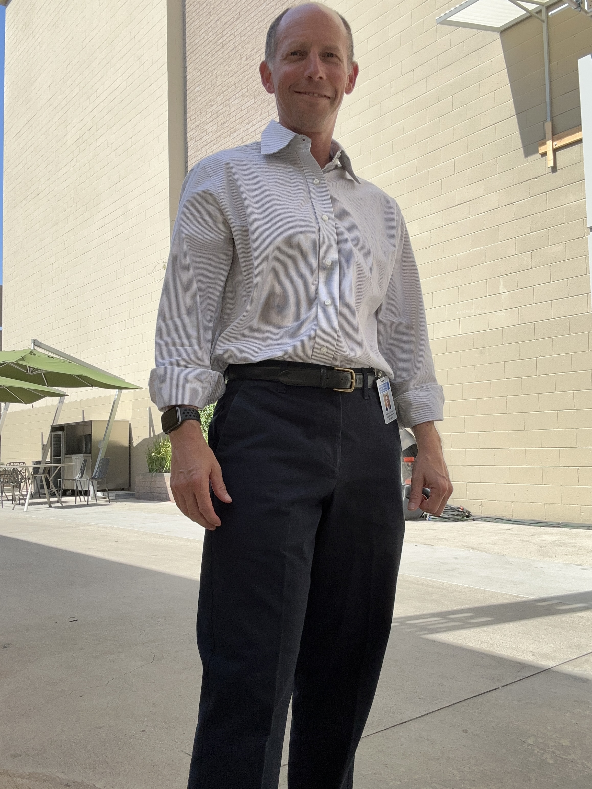 Randy Loveridge in hospital staff wardrobe with an identification badge on the set of Grey's Anatomy